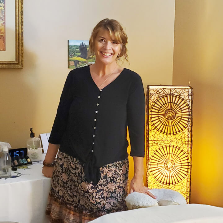Kat Pisani standing in massage therapy room