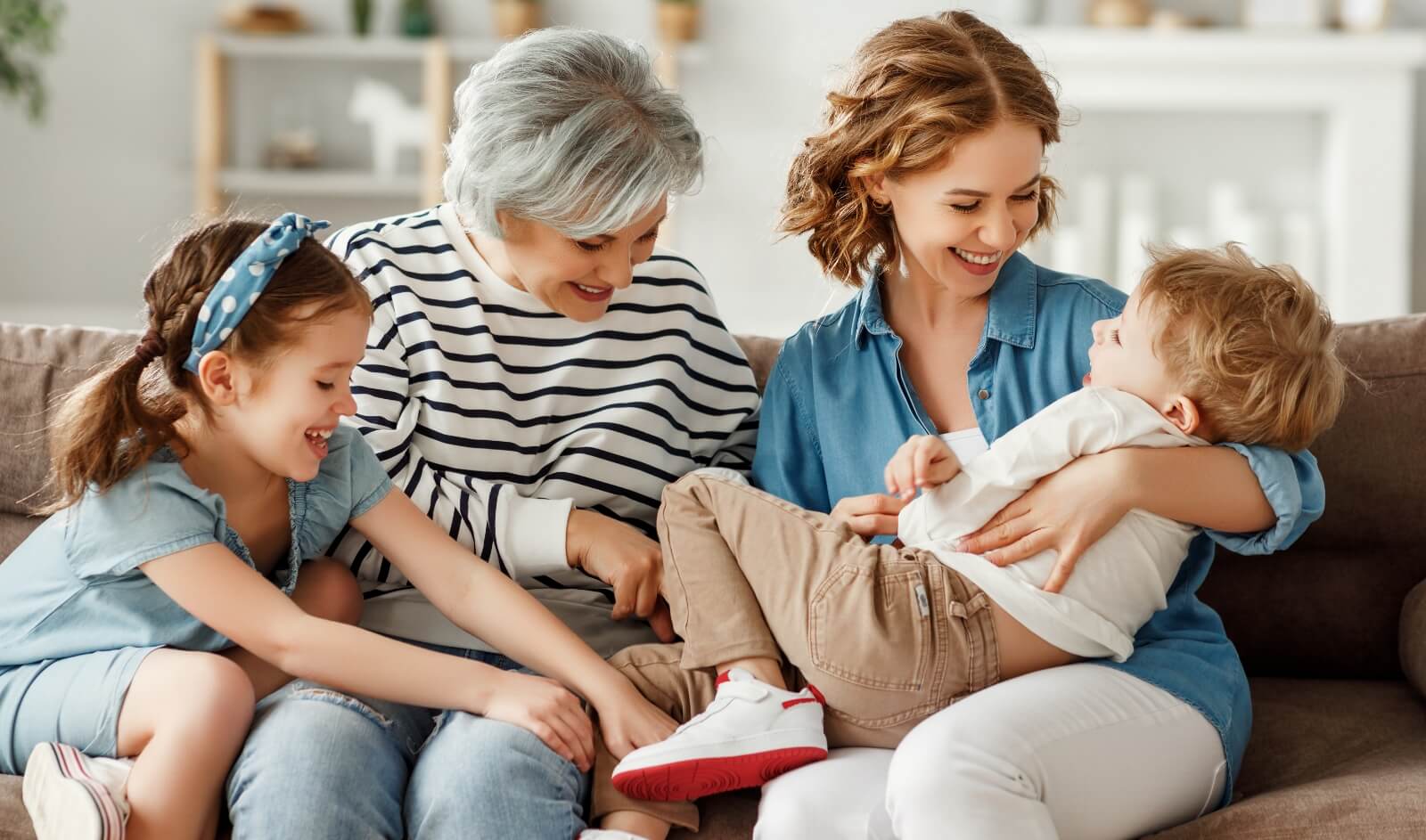 grandmother, mom, and kids playing on couch