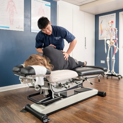patient on table having back adjusted