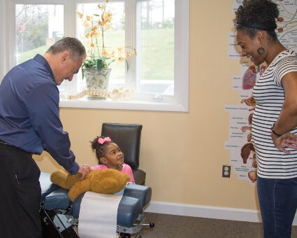 Palmyra chiropractor Dr. Caratozzolo in consultation with pediatric patient