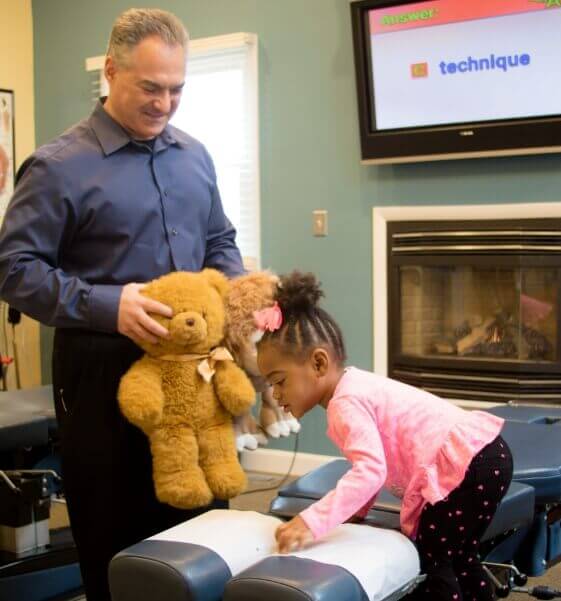 Palmyra chiropractor Dr. Carmelo Cartazzolo interacting with pediatric patient