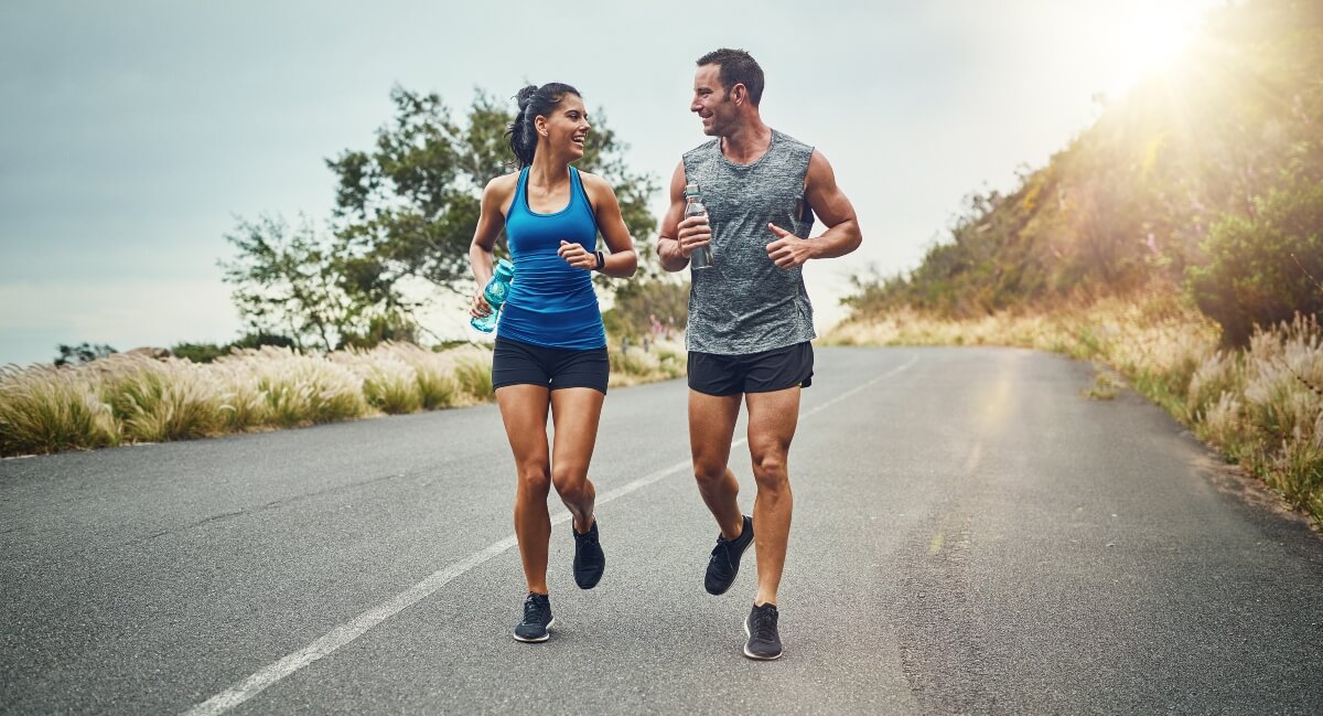 Man and woman running on a road