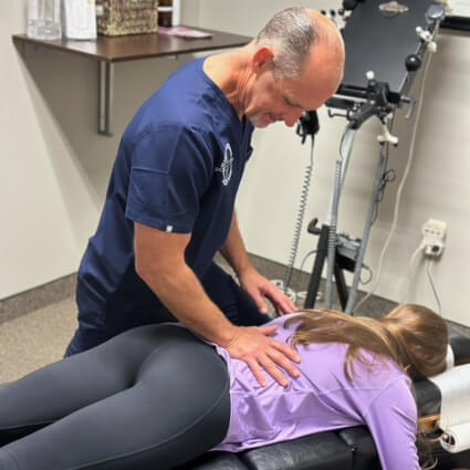 Philadelphia Chiropractic Dr. Frank adjusting woman's back