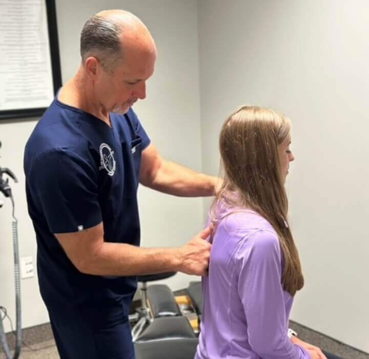 Dr. Frank adjusting woman's back