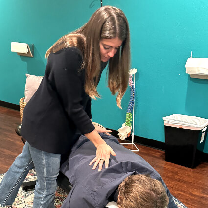 Cook Chiropractic Center doctor adjusting patients back