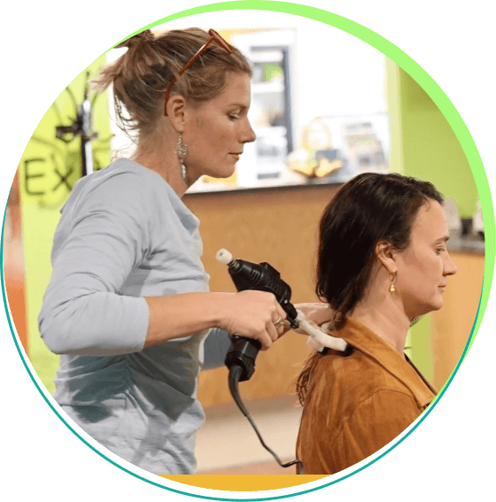 Cook Chiropractic Center chiropractor using massage gun