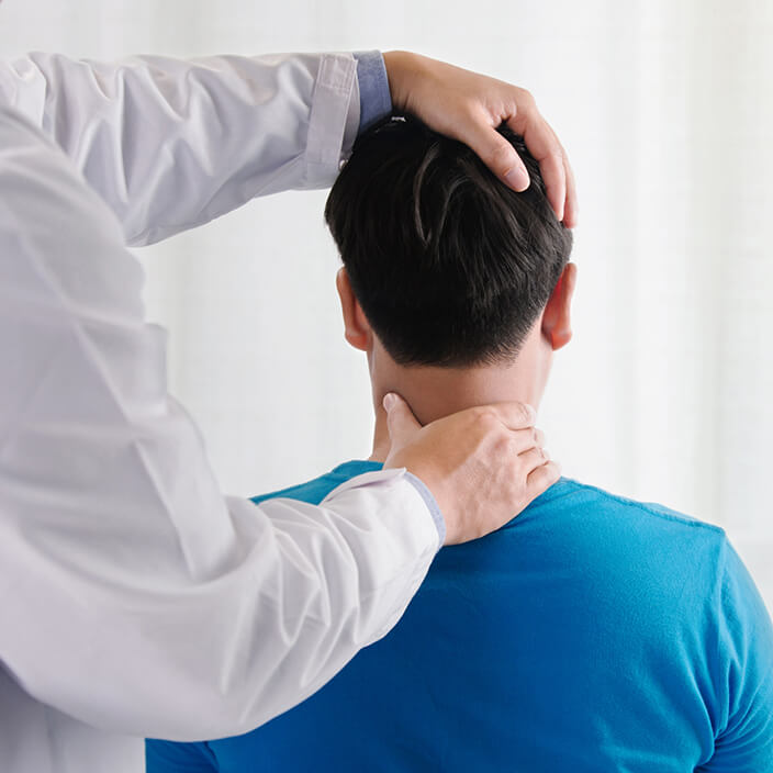 Chiropractor adjusting man's neck