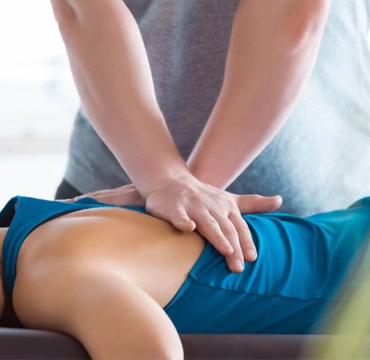 hands pressing on woman's back