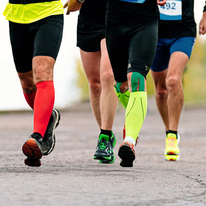 Men running wearing compression socks