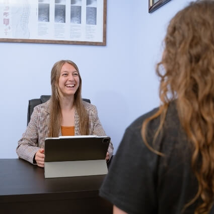 City Chiropractic's Nicole talking with patient