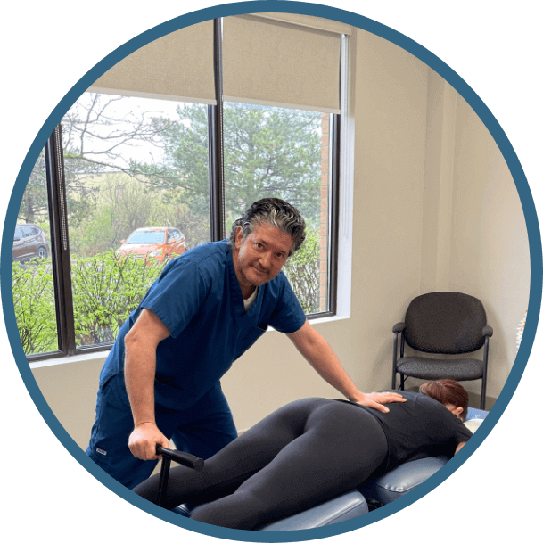 Waterloo Chiropractor Dr. Marco with patient on adjusting table