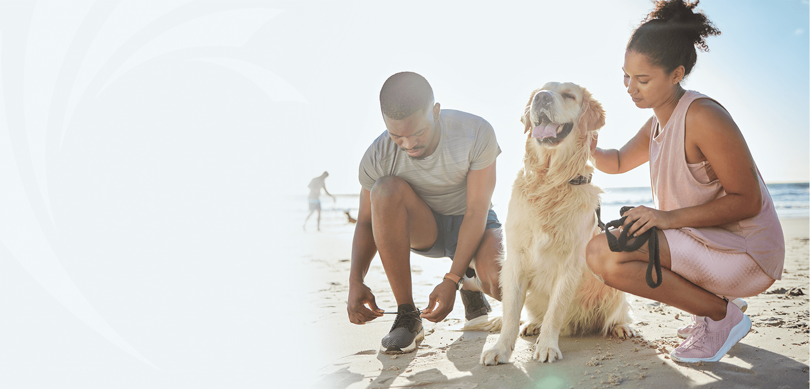 couple with dog at the beach