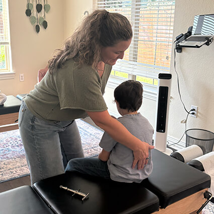Dr Sarah sitting back check up child patient
