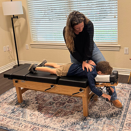 dr-sarah-upper-back-adjustment-child-patient