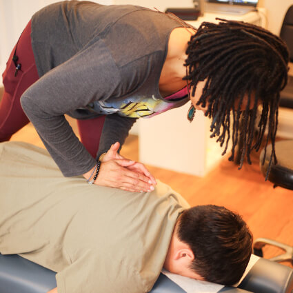 Lawrenceville Chiropractor Dr. Makeda doing back adjustment