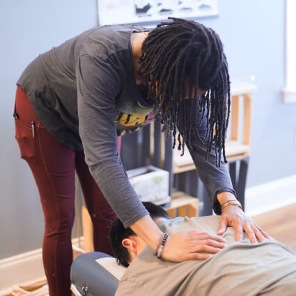 Lawrenceville Chiropractor Dr. Makeda pressing on back