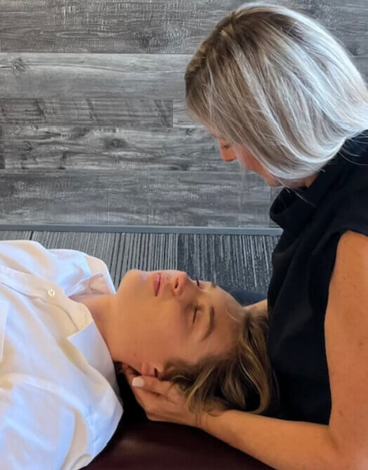 Orangeville chiropractor Dr. Pam adjusting patients neck