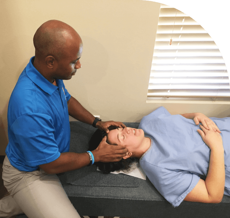 Round Rock chiropractor Dr Bolden adjusting patient massaging patient