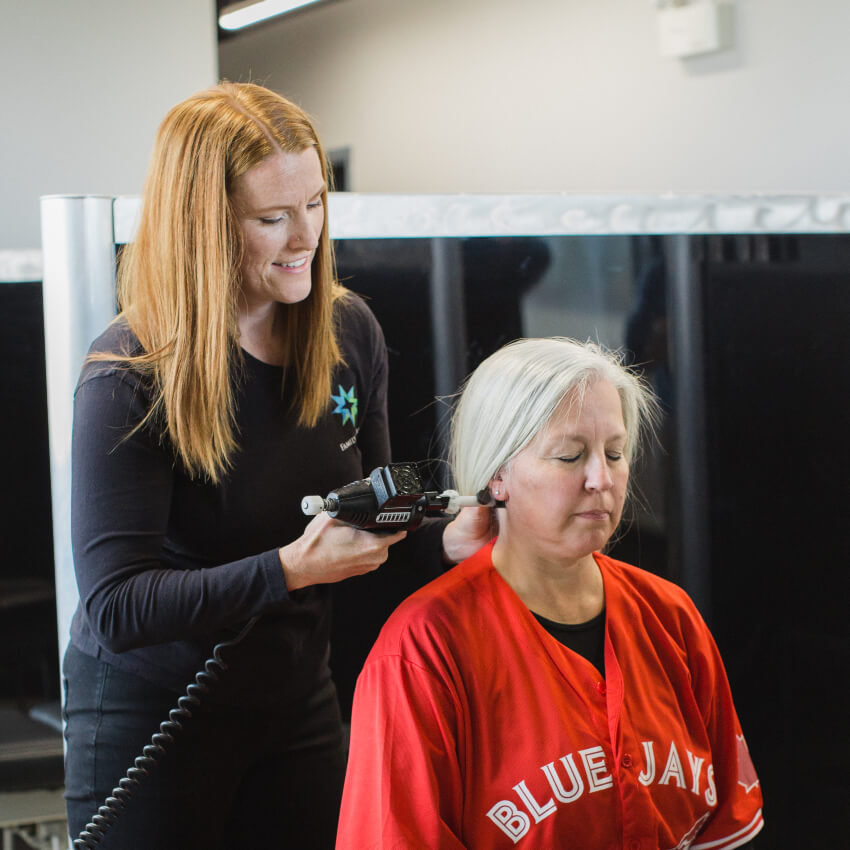 Dr Lauren adjusting patients neck with tool