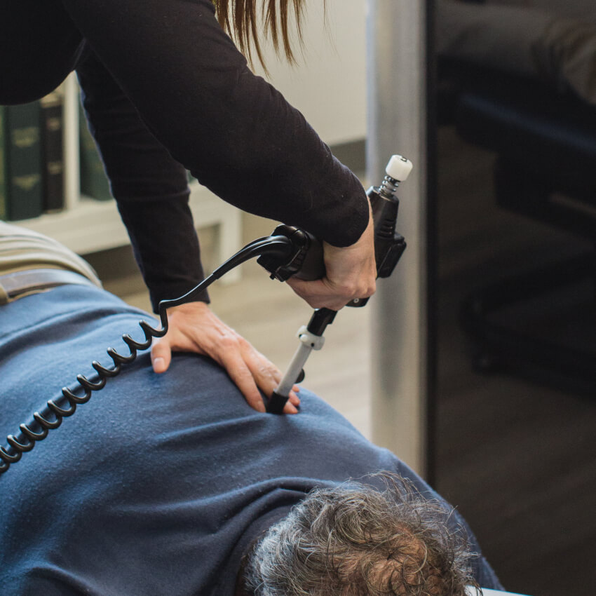 Dr Lauren adjusting patients back with tool