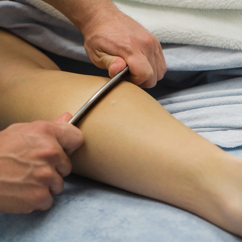 graston tool being used on patients leg