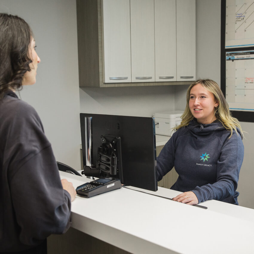Family Legacy Chiropractic front desk team checking in a patient