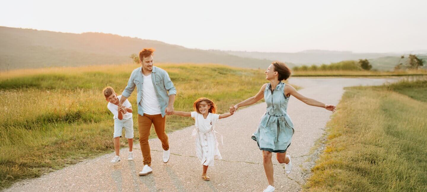 family of four walking outdoors