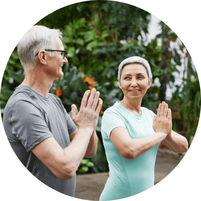 two people meditating outdoors