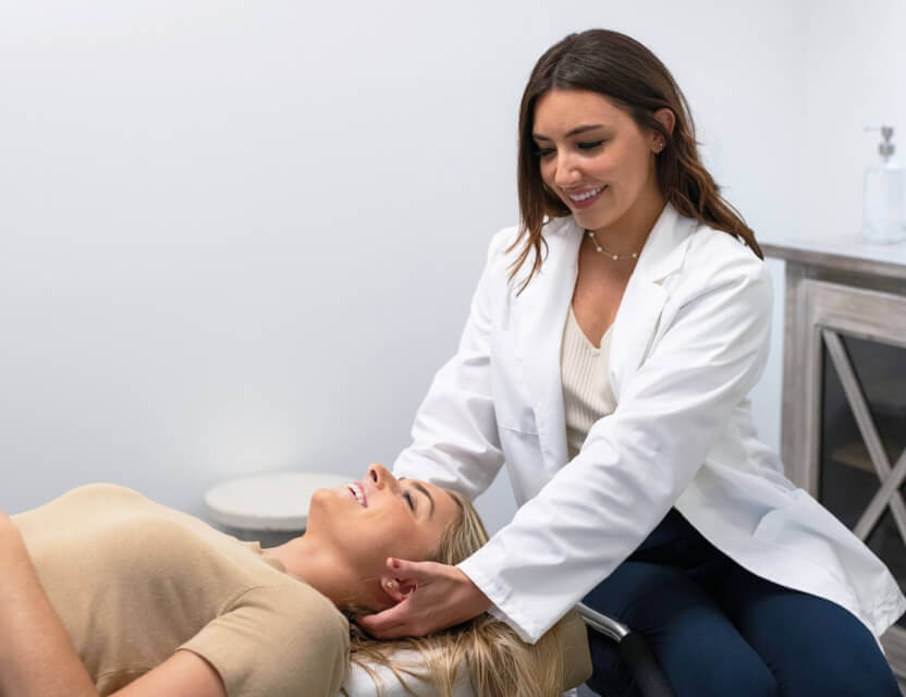 Champions Gate chiropractor Dr. Audra adjusting patient's neck