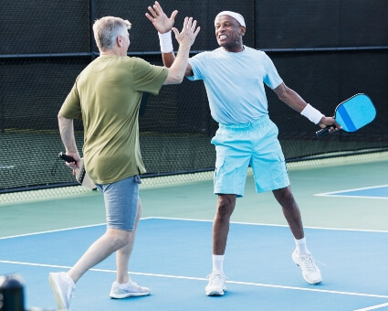 Two men playing pickleball