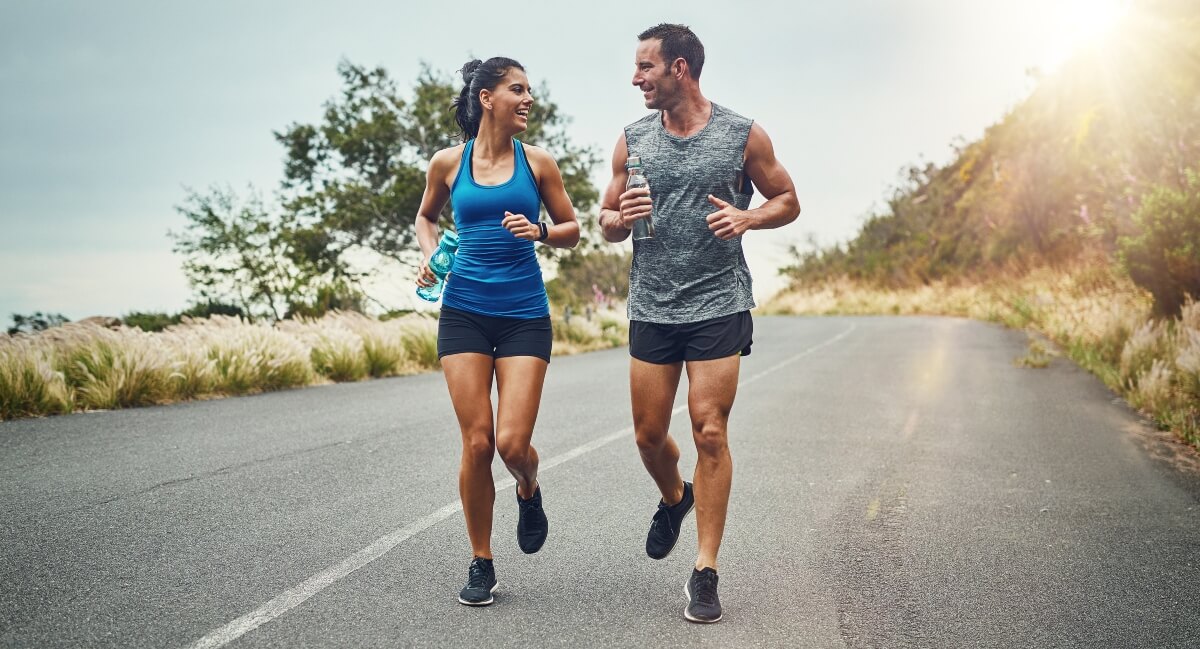 Woman and man running on road