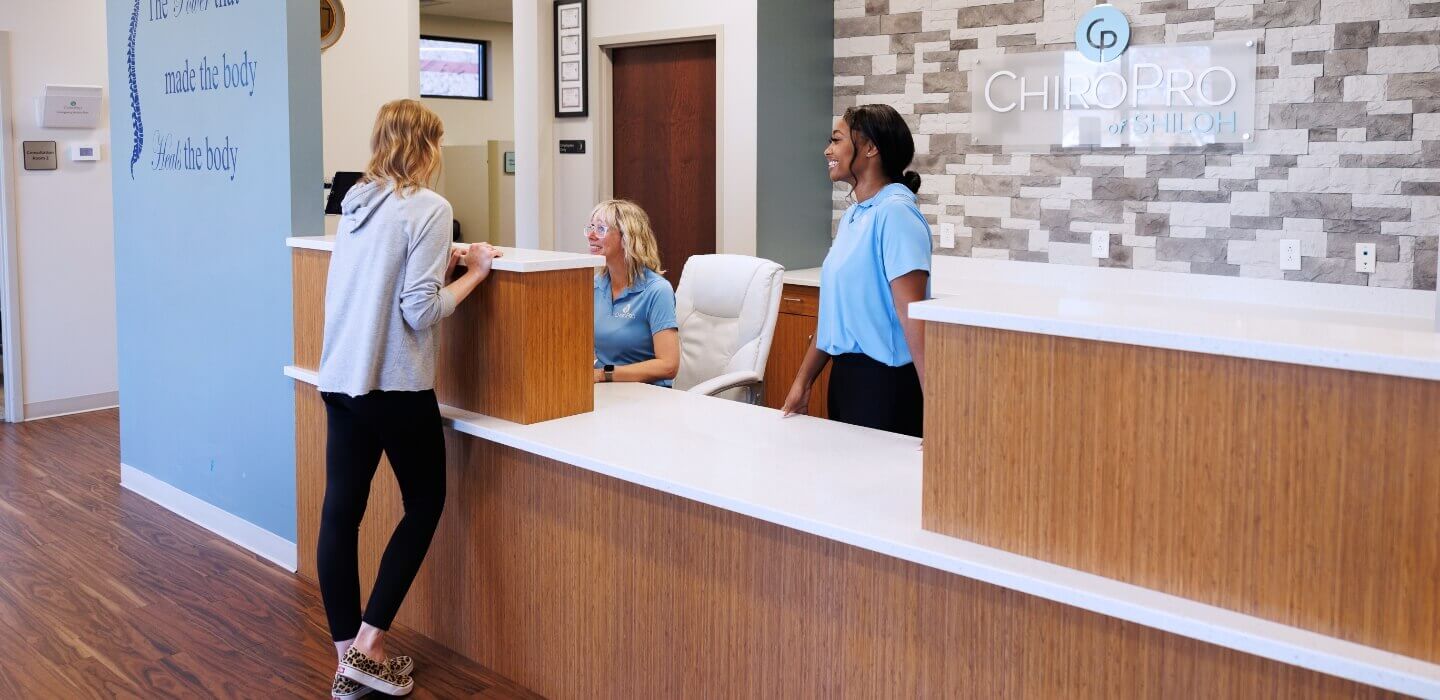 patient checking in at ChiroPro front desk