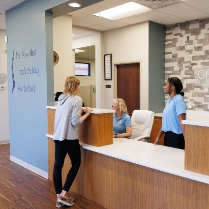 patient at ChiroPro front desk