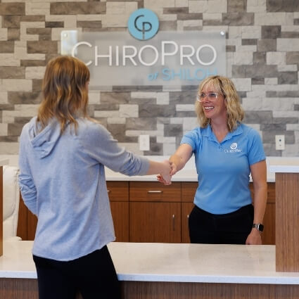 Patient checking in at ChiroPro front desk