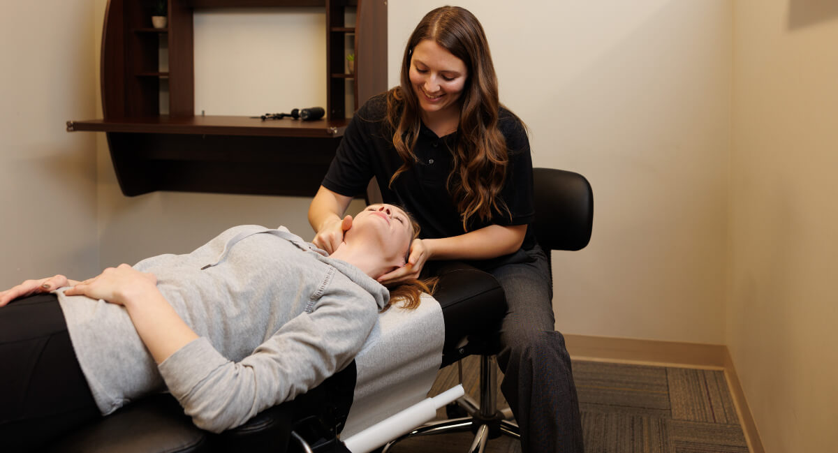 St. Louis chiropractor Dr. Baily adjusting female patient's neck