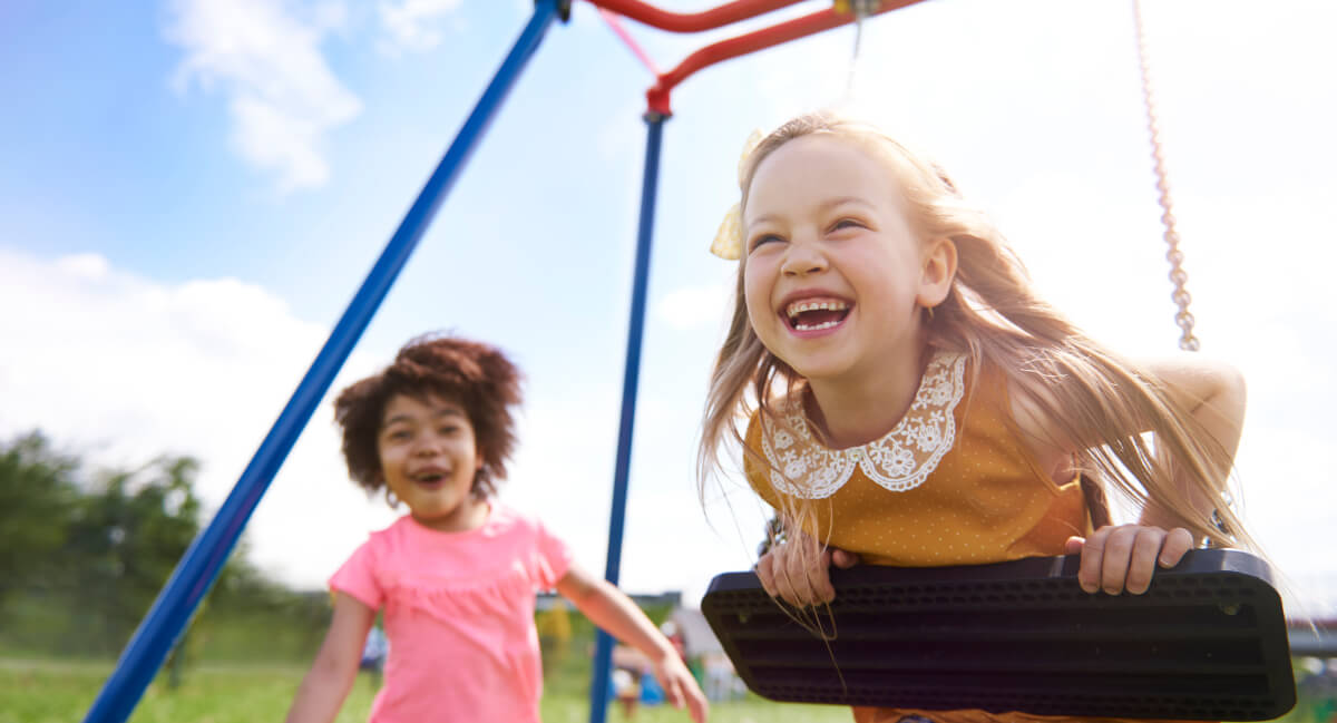 Girls playing on the swing