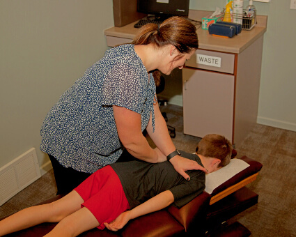 First Chiropractic Centers P.C. chiropractor adjusting childs back