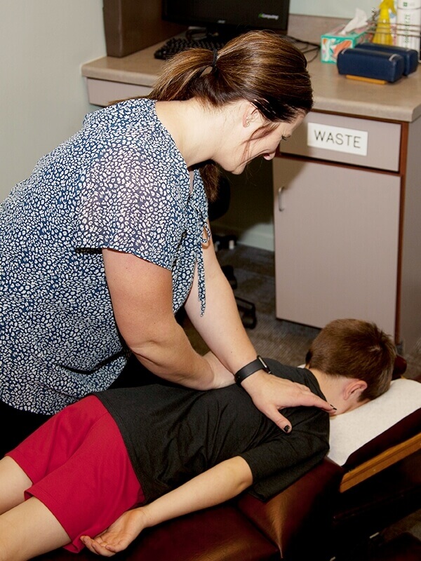 First Chiropractic Centers P.C. chiropractor adjusting childs neck