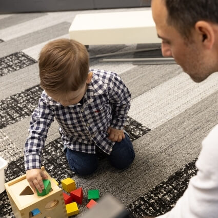 Adjusted Health doctor and child playing together