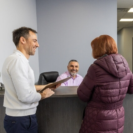 Adjusted Health patient talking with staff at our front desk