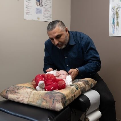 Orillia chiropractor Dr Leon adjusting baby