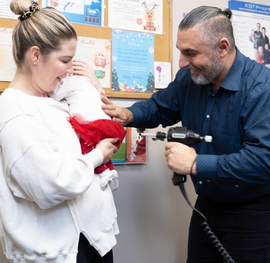 Orillia chiropractor Dr Leon using adjusting tool on baby