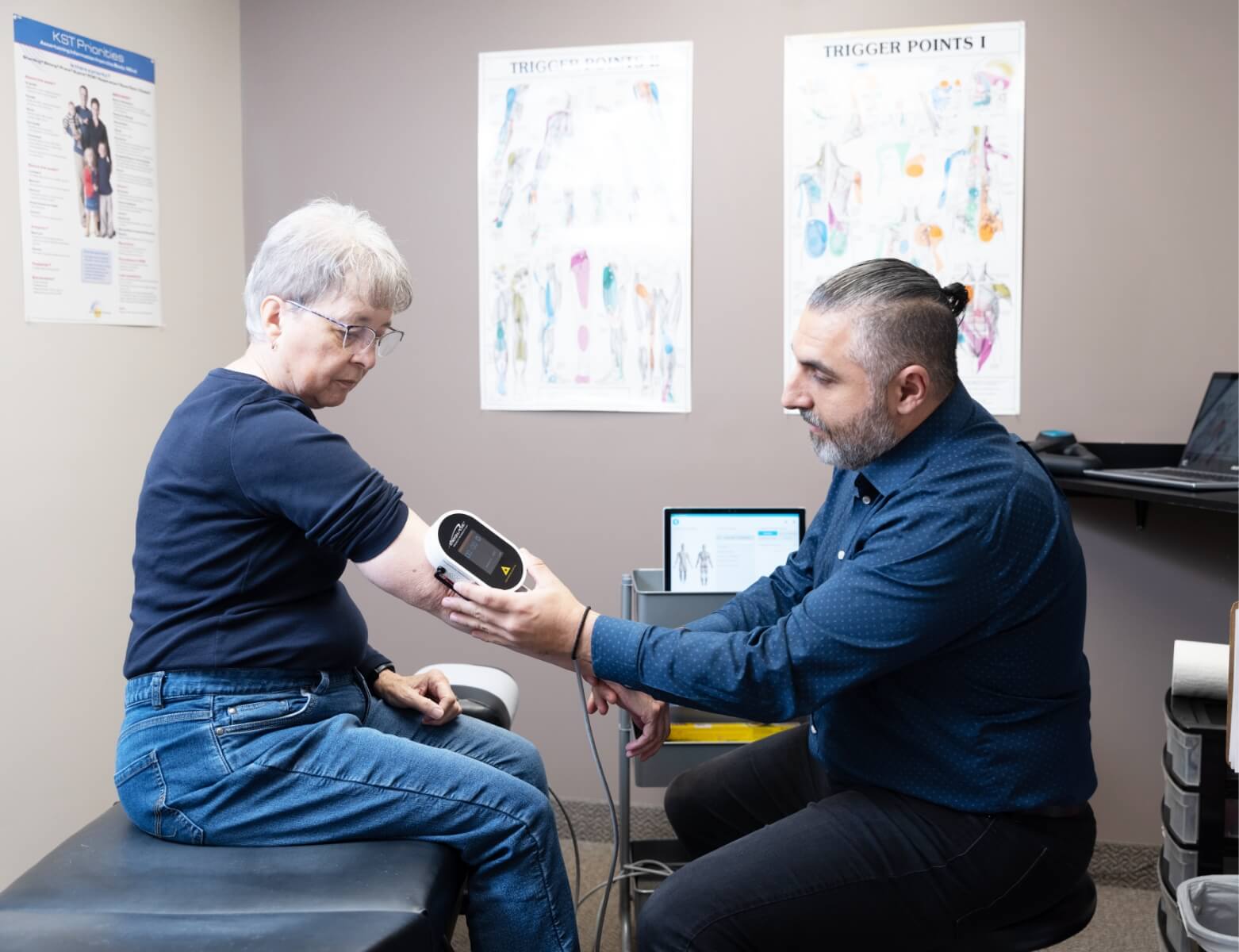 Restore Chiropractic & Wellness Centre's Dr Leon using tool on patients arm