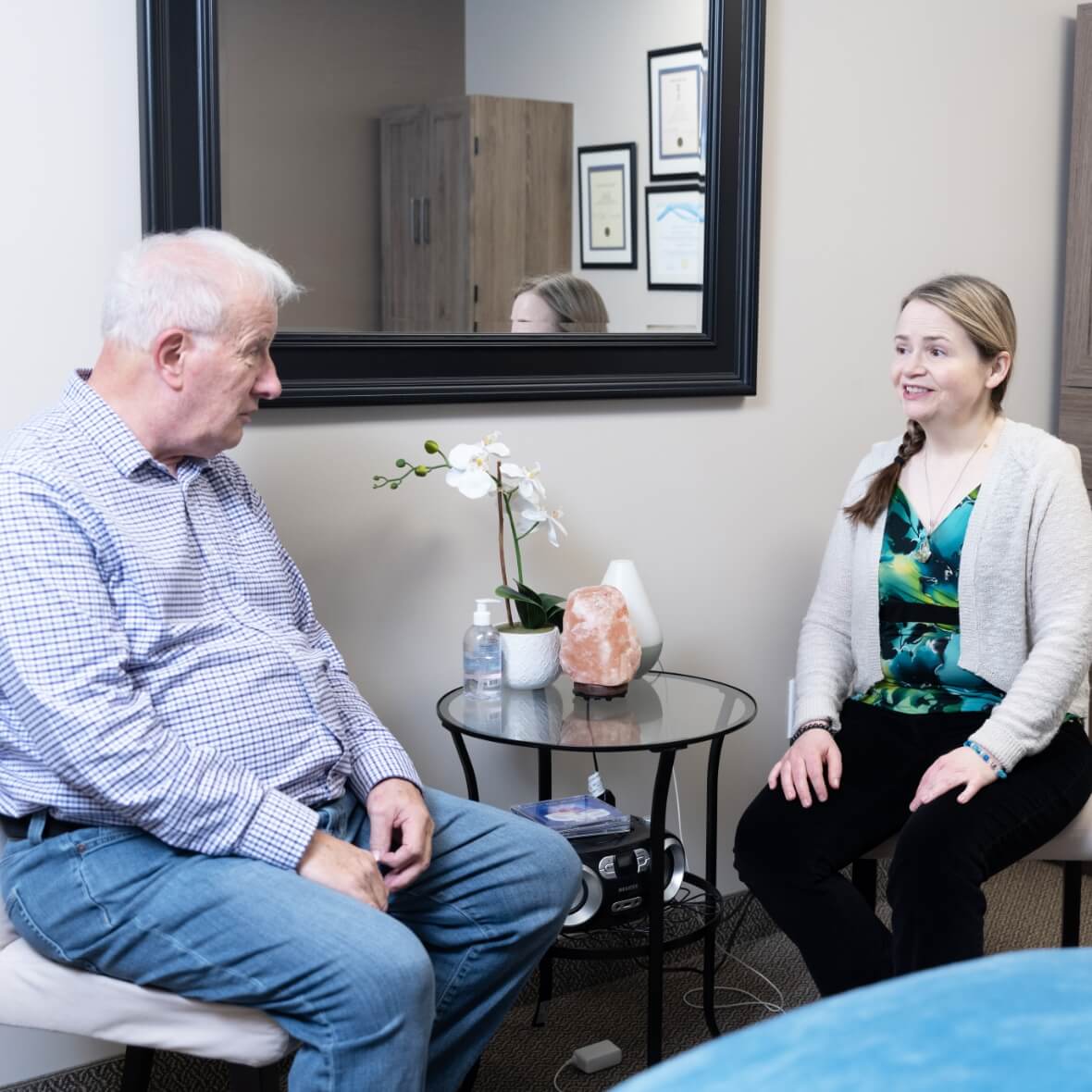 Restore Chiropractic & Wellness Centre's Mary talking with patient