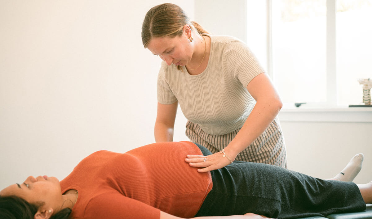 Chiropractor adjusting pregnant woman