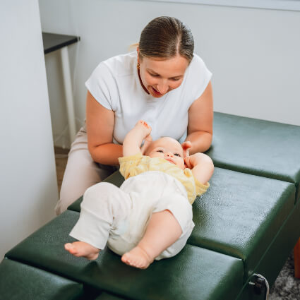 Chiropractic First Chiropractor Dr. Motion adjusting baby's neck