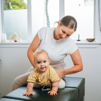 Dr. Motion adjusting baby on table