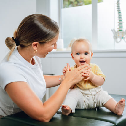 Chiropractic First Chiropractor Dr. Motion with baby on table