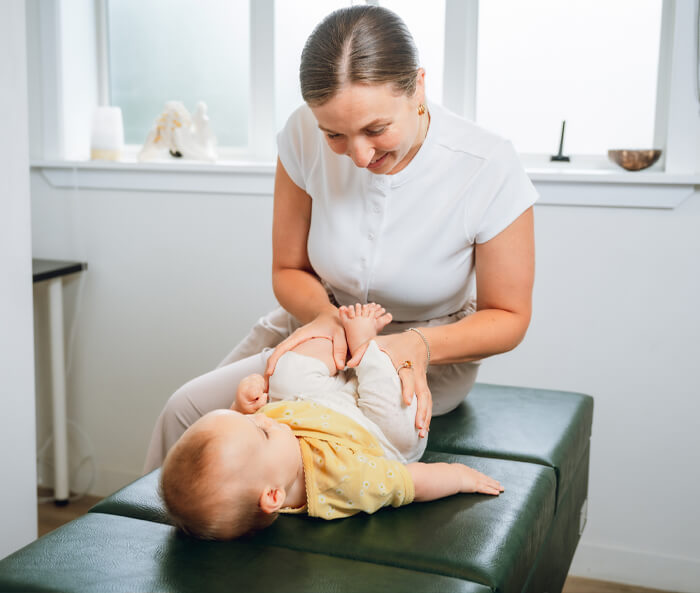 Chiropractor adjusting baby