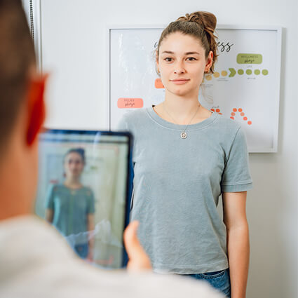 Patient getting her posture checked